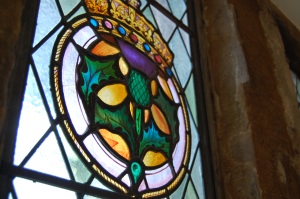 Royal badge of James V in the office (currently hidden behind all our scaffolding). You can just about make out that the window is bulging inwards and has caused some of the glass to fracture. 